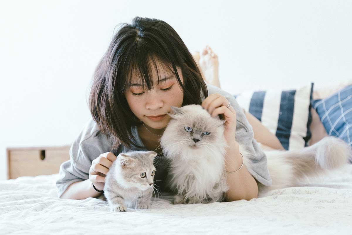 Woman with two cats