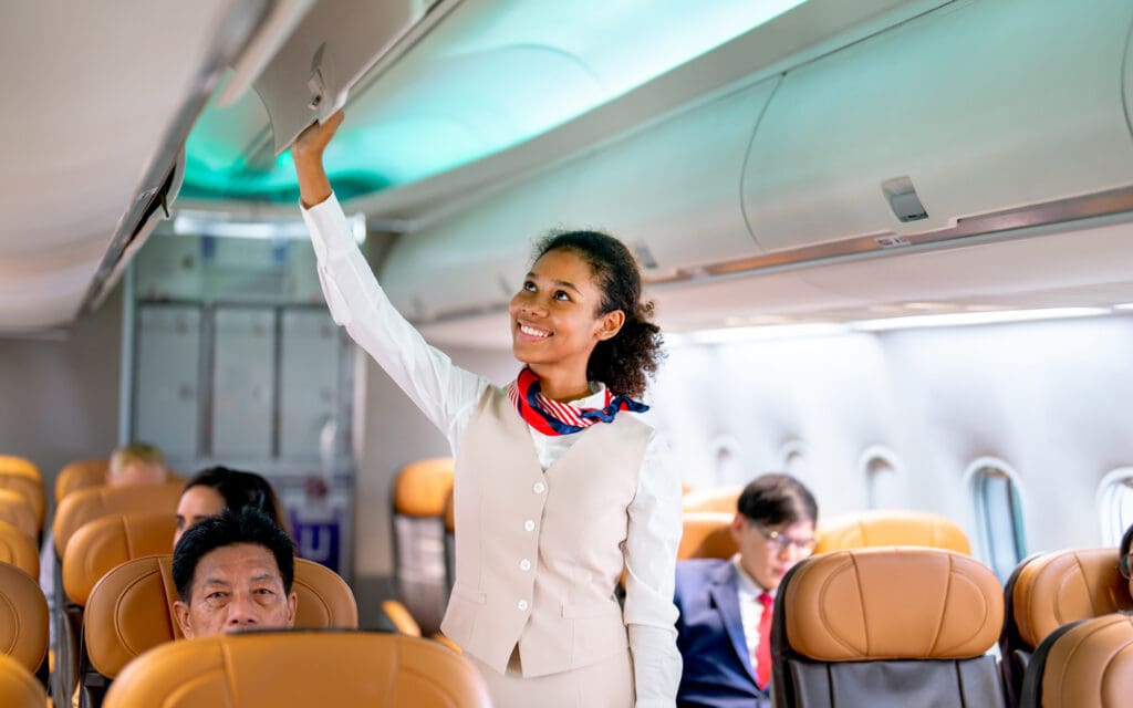 Flight Attendant Closing Overhead Compartment