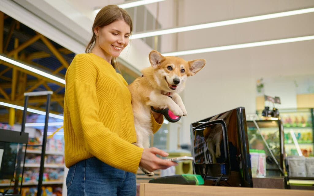 Woman with Corgi in pet shop