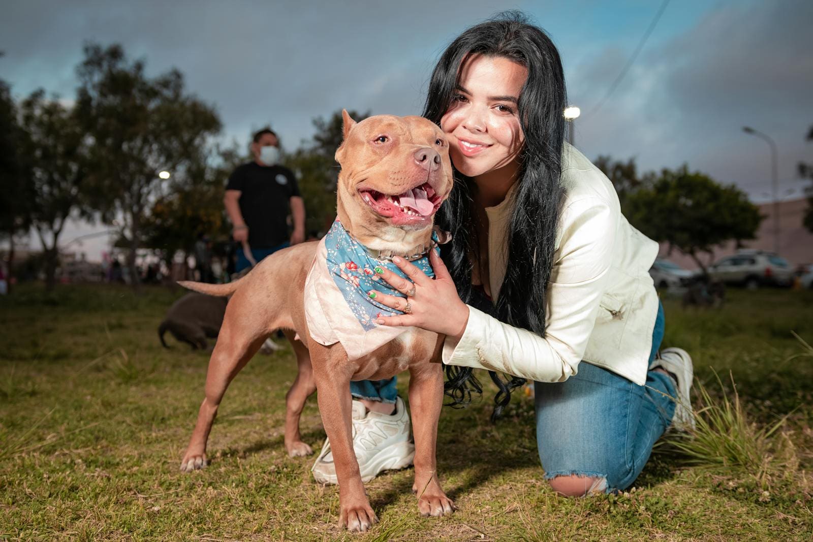 Brunette Woman Hugging Dog on Grass