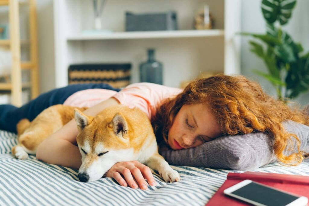 Redhead Woman Sleeping with Dog