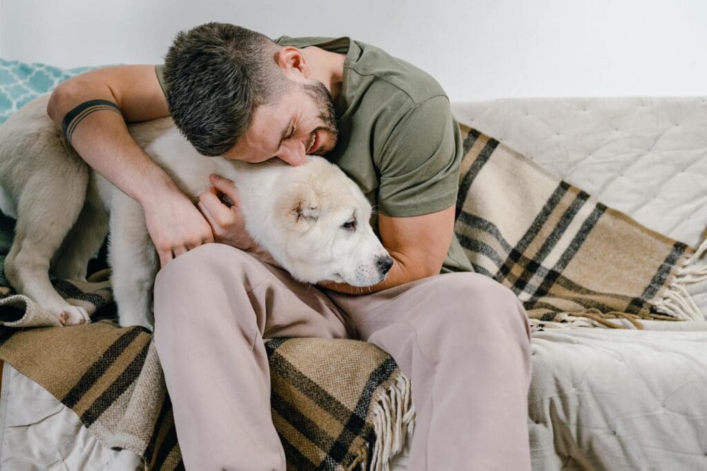 Photograph of a Man Hugging His Dog