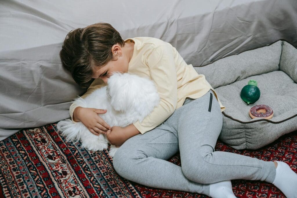 A Boy Cuddling with His Dog