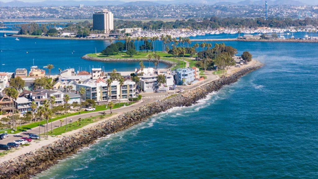 Stunning drone shot of San Diego's coastline, showcasing urban cityscape and ocean views.