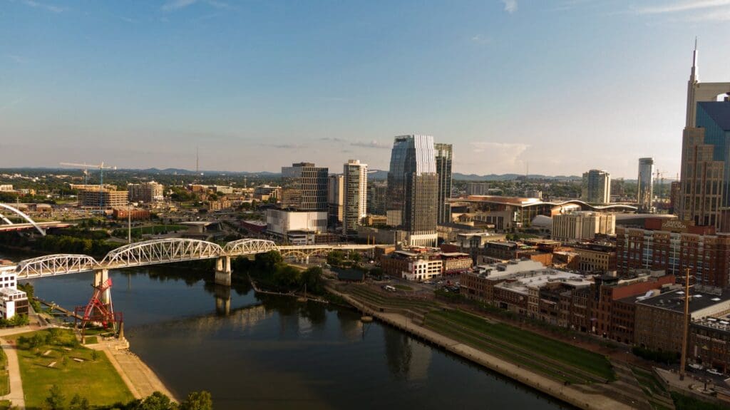 Drone photo of Nashville's skyline with bridges and river.