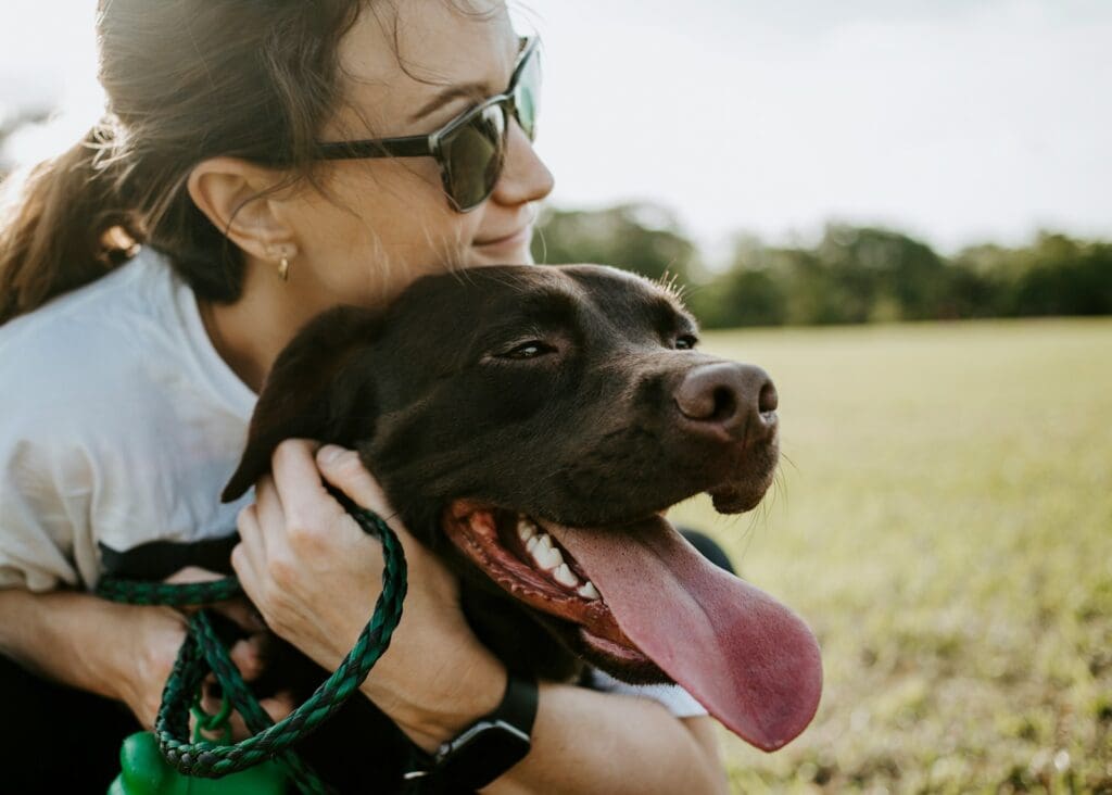 woman hugging a labrador
