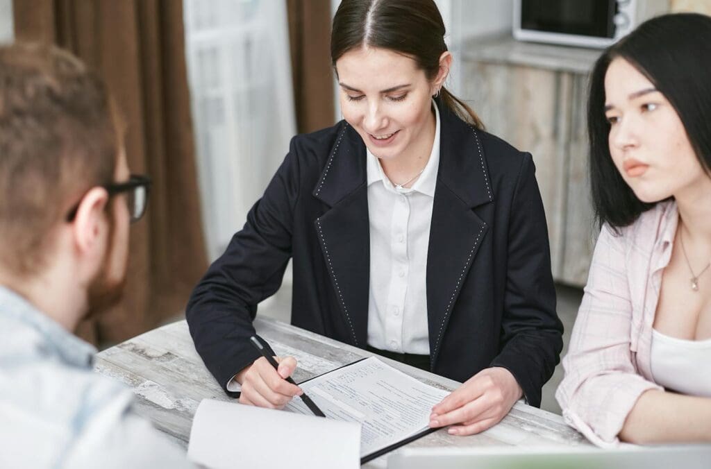 A business meeting with a diverse team indoors, discussing documents and investments.